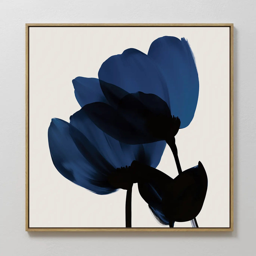 The Bloom Abstract Canvas Art – Square features two abstract blue flowers with dark stems and a light background. Soft brushstrokes and a minimalist look make it ideal modern wall art for your living room decor.