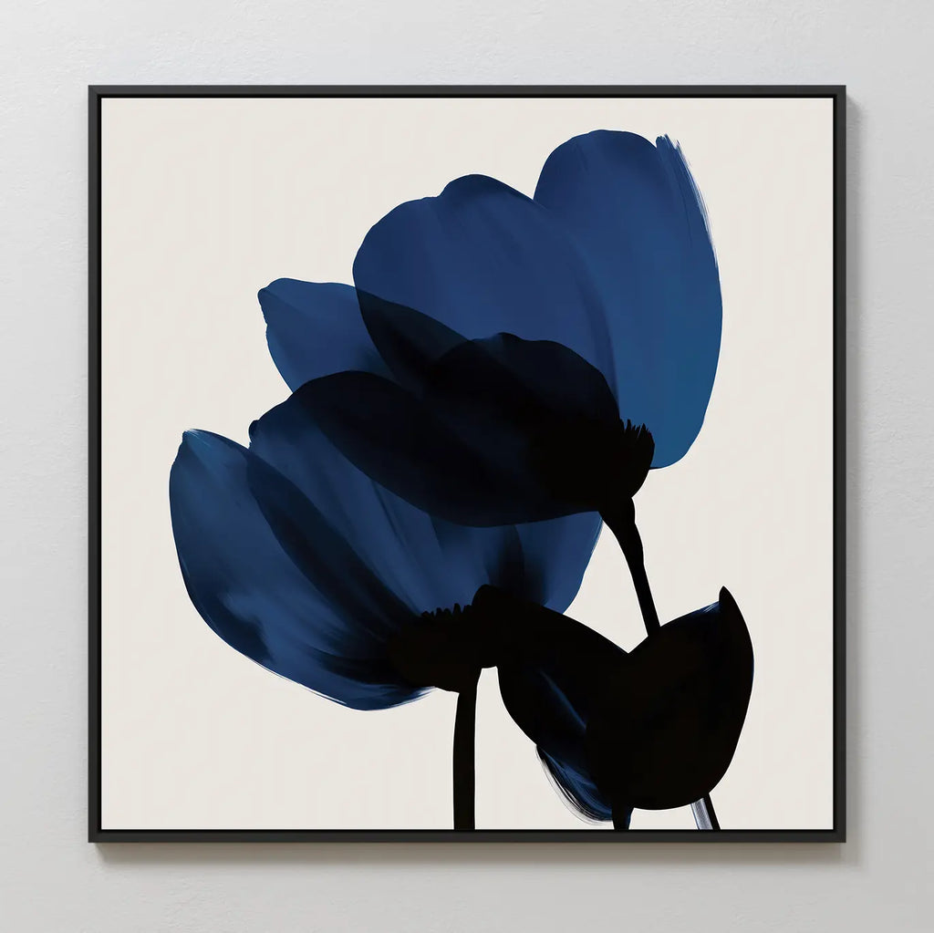 The Bloom Abstract Canvas Art – Square features three minimalist dark blue flowers with black stems on an off-white background, framed in a sleek black square—ideal modern wall art for any contemporary living room.