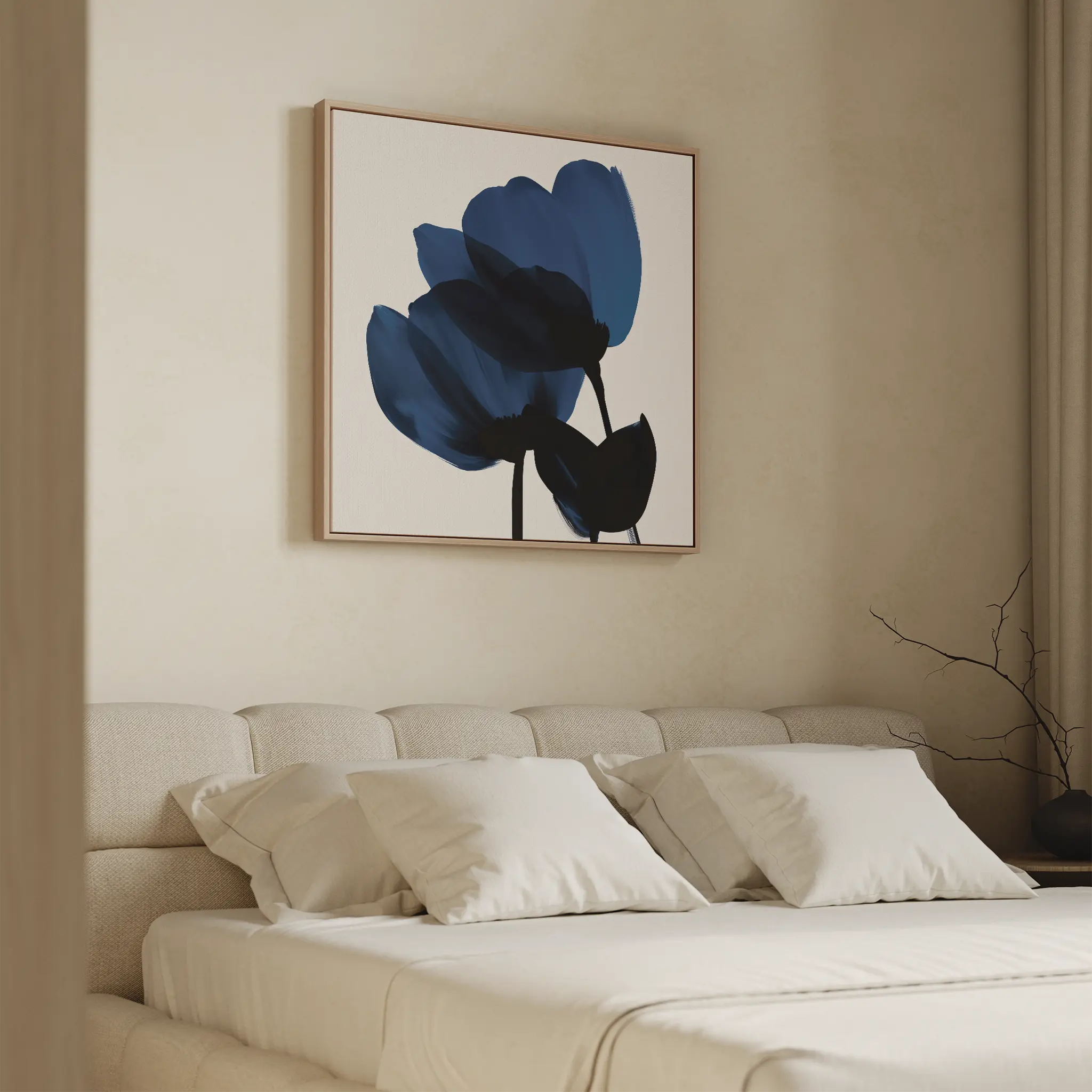 Minimalist bedroom with a beige bed, white pillows, and Bloom Abstract Canvas Art – Square featuring blue flowers above the headboard. A vase with bare branches on a side table enhances the serene atmosphere.