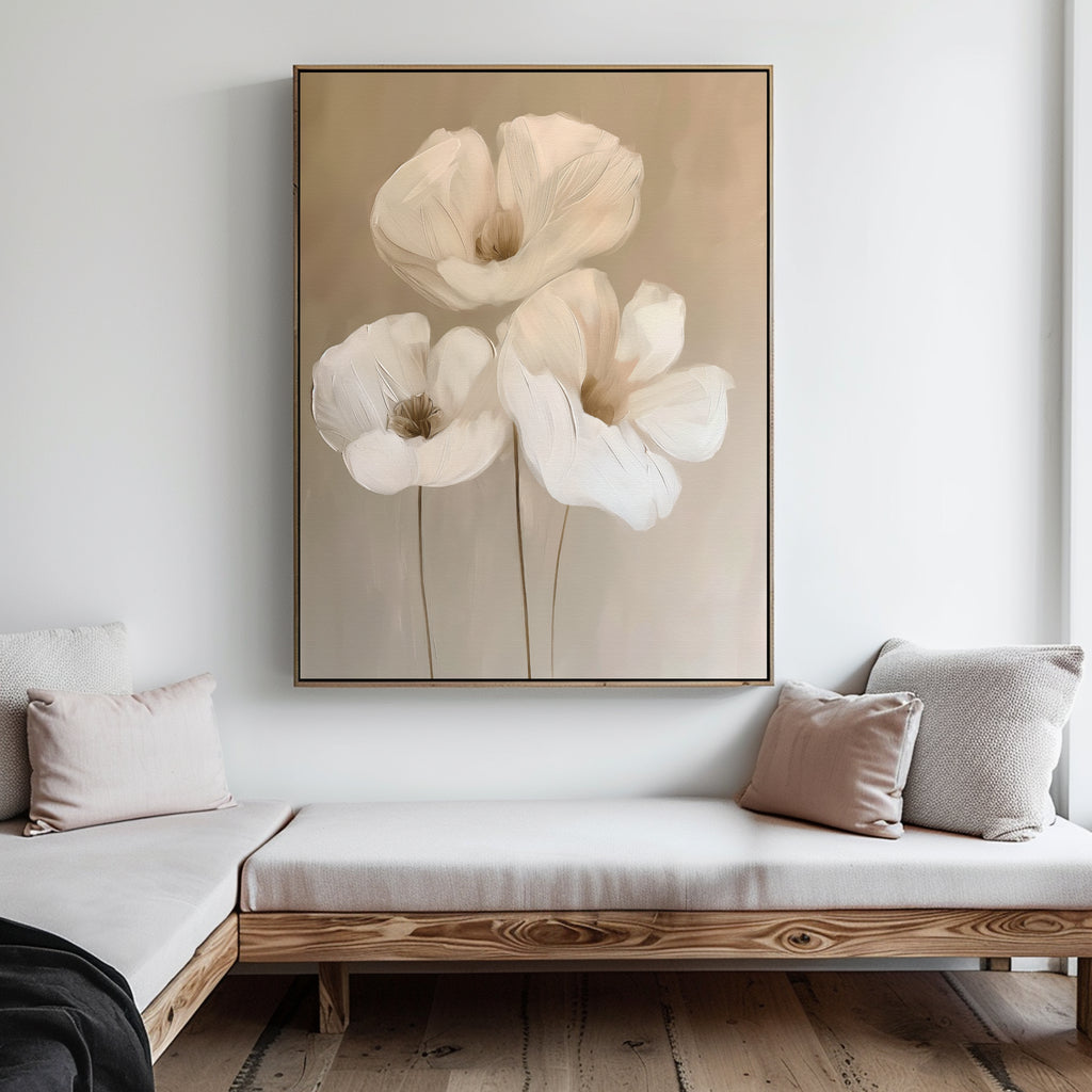 The Blossom Trio Abstract Canvas Art, featuring three white flowers with long stems, hangs above a wooden bench with neutral cushions in a minimalist living room.
