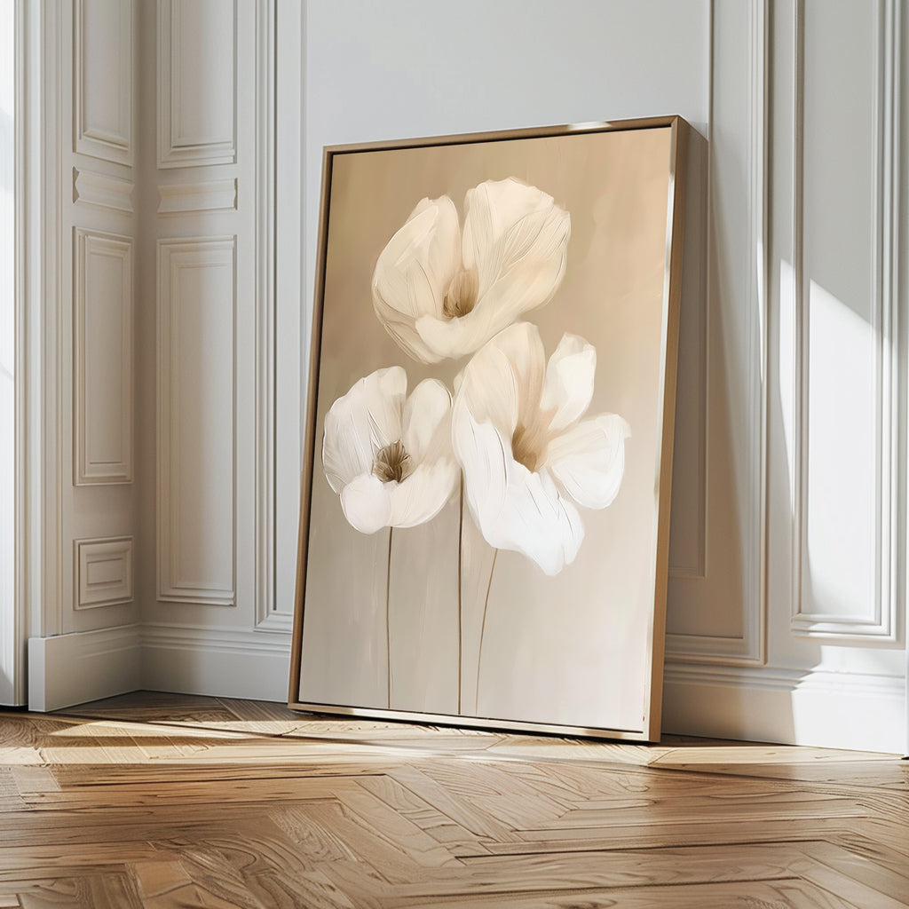 The Blossom Trio Abstract Canvas Art, featuring three white flowers with delicate petals, leans against a white paneled wall on a wooden floor, adding minimalist elegance and style to this bright room.