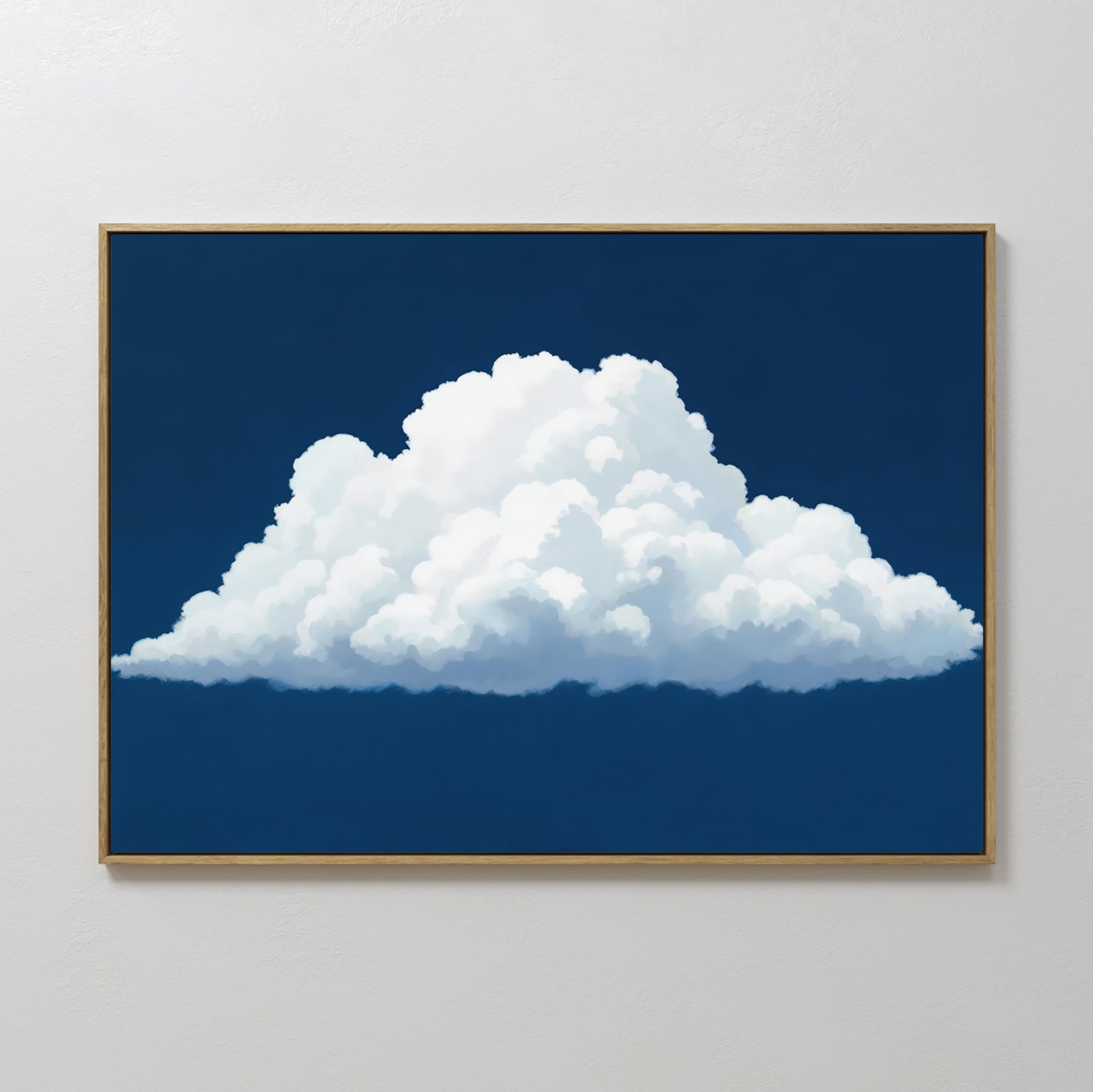 The Blue Horizon Cloud Canvas Art showcases a fluffy white cloud on a deep blue sky, framed and displayed on a white wall—ideal minimalist decor for modern living rooms.