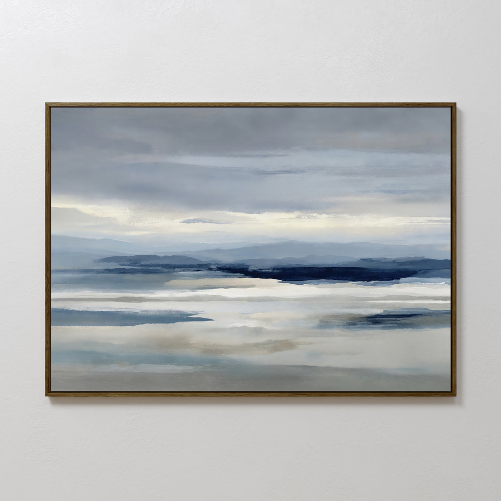 The Blue Mist Horizon Canvas Art features minimalist blue, gray, and white tones in a serene landscape of calm water and distant mountains, creating a tranquil atmosphere perfect for living room decor.