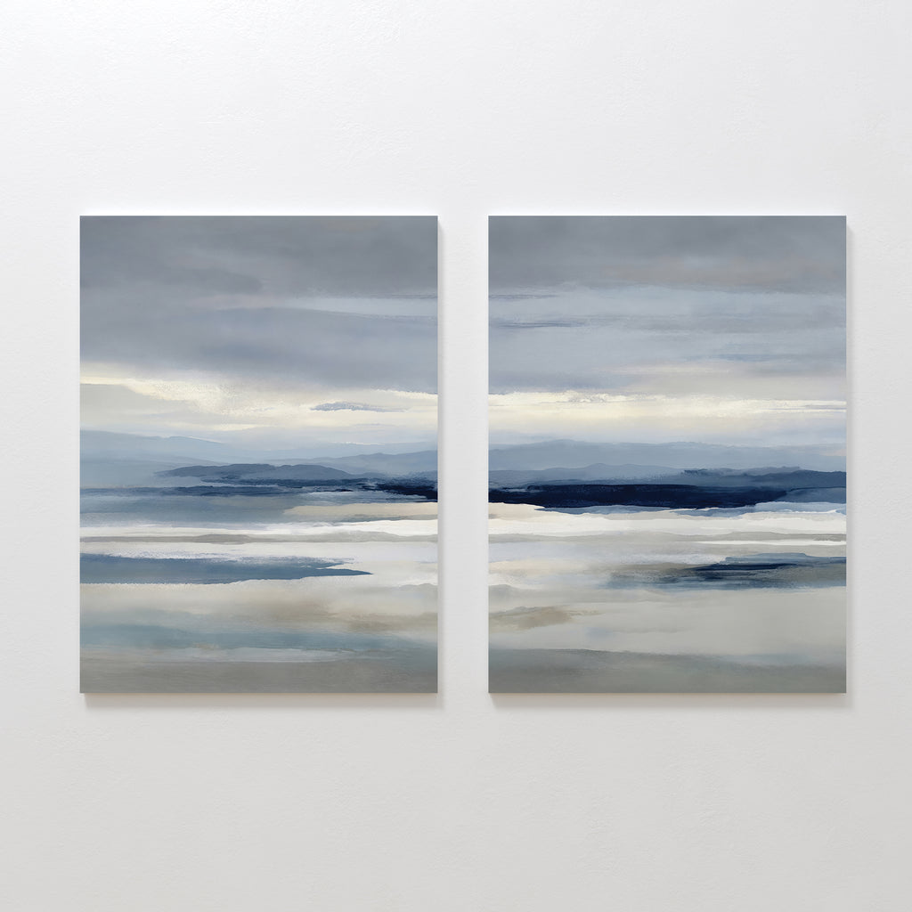 The Blue Mist Horizon Set of 2 features abstract paintings in soft blue, gray, and white tones, creating a serene seascape. These large canvas prints add minimalist elegance and calm to your living room décor.