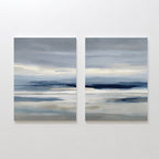 The Blue Mist Horizon Set of 2 features abstract paintings in soft blue, gray, and white tones, creating a serene seascape. These large canvas prints add minimalist elegance and calm to your living room décor.