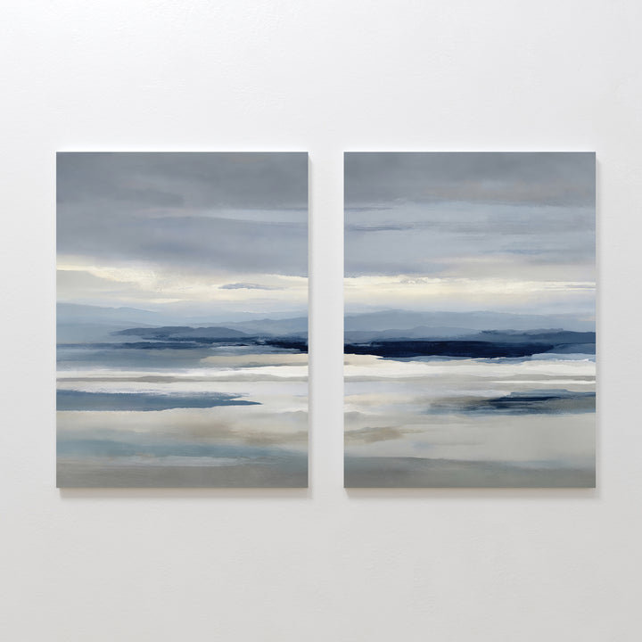 The Blue Mist Horizon Set of 2 features abstract paintings in soft blue, gray, and white tones, creating a serene seascape. These large canvas prints add minimalist elegance and calm to your living room décor.