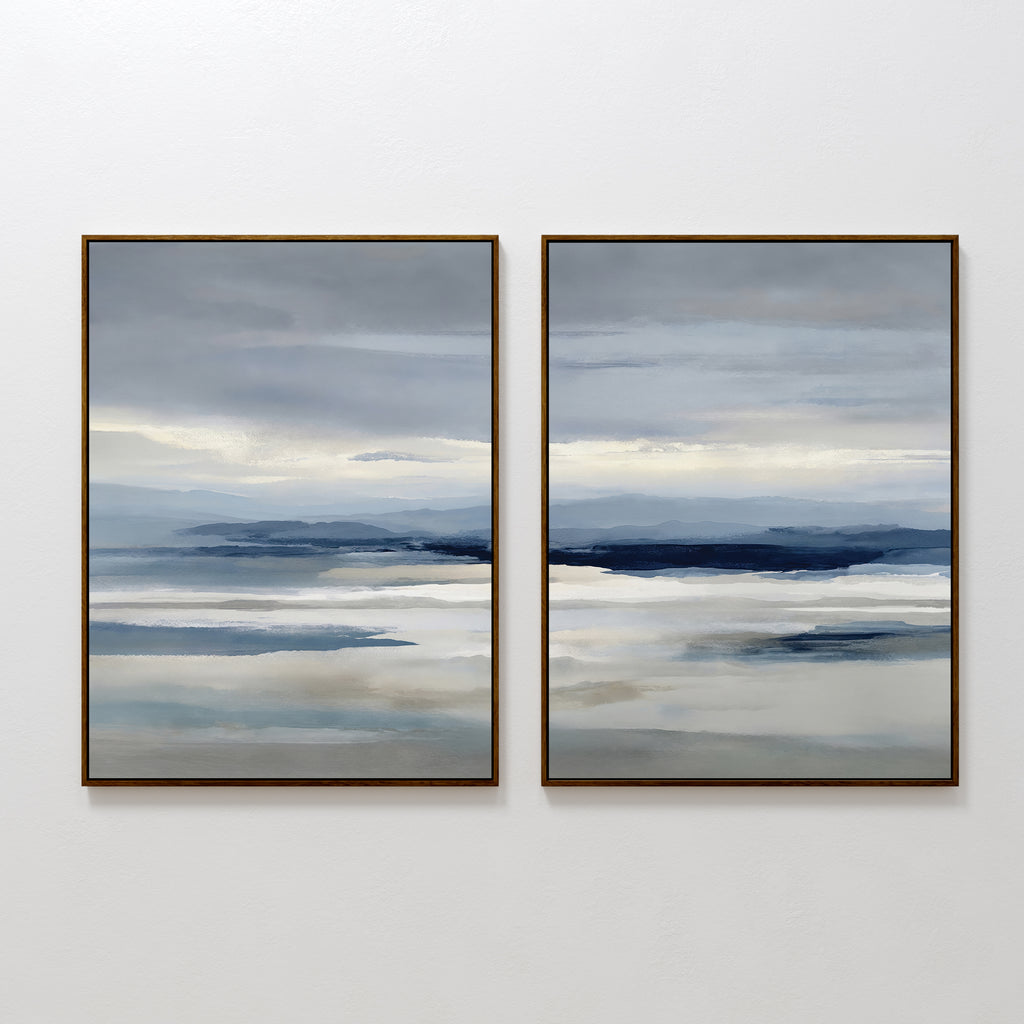 The Blue Mist Horizon Set of 2 features framed, minimalist abstract landscapes in layered blue, gray, and beige. These large canvas prints resemble misty water and distant mountains, perfect as modern wall art for living room decor.