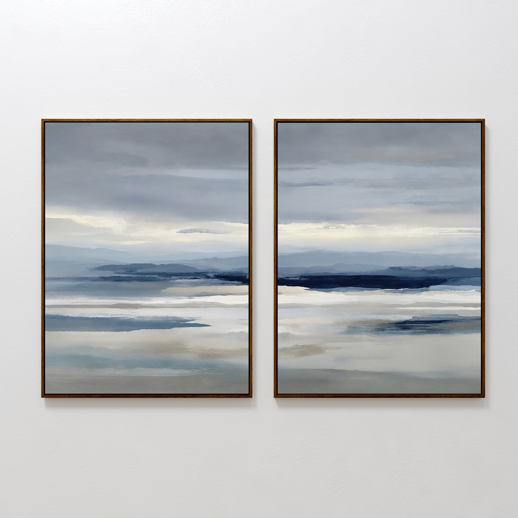 The Blue Mist Horizon Set of 2 features framed, minimalist abstract landscapes in layered blue, gray, and beige. These large canvas prints resemble misty water and distant mountains, perfect as modern wall art for living room decor.