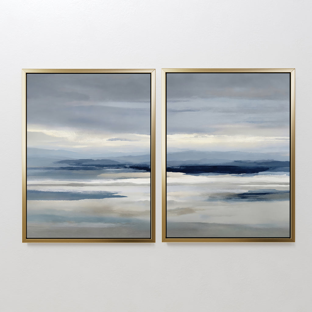 The Blue Mist Horizon Set of 2 features abstract landscape paintings in blue, gray, and beige, framed and hung side by side on a white wall, adding a serene, minimalist touch to your living room decor.