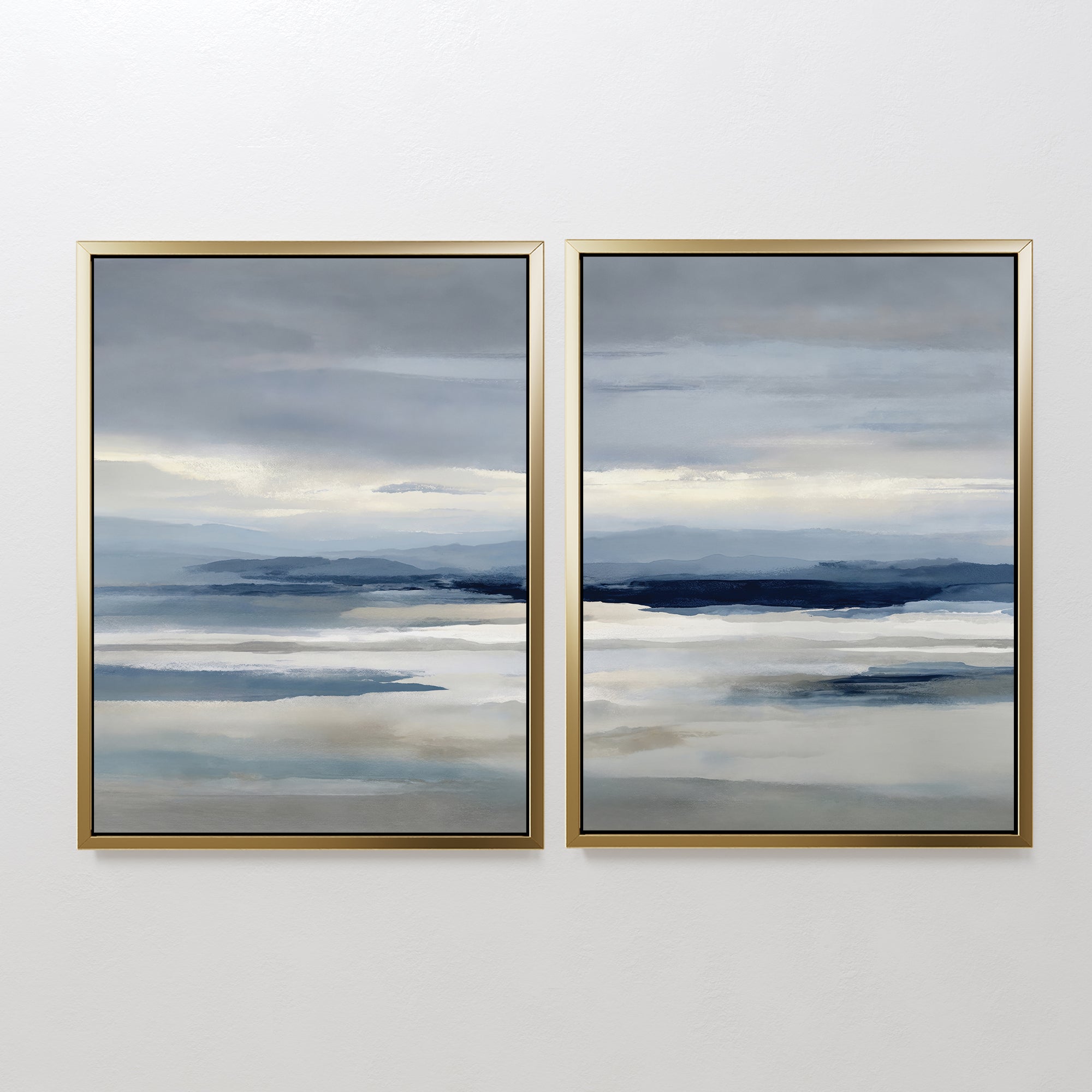 The Blue Mist Horizon Set of 2 features abstract landscape paintings in blue, gray, and beige, framed and hung side by side on a white wall, adding a serene, minimalist touch to your living room decor.