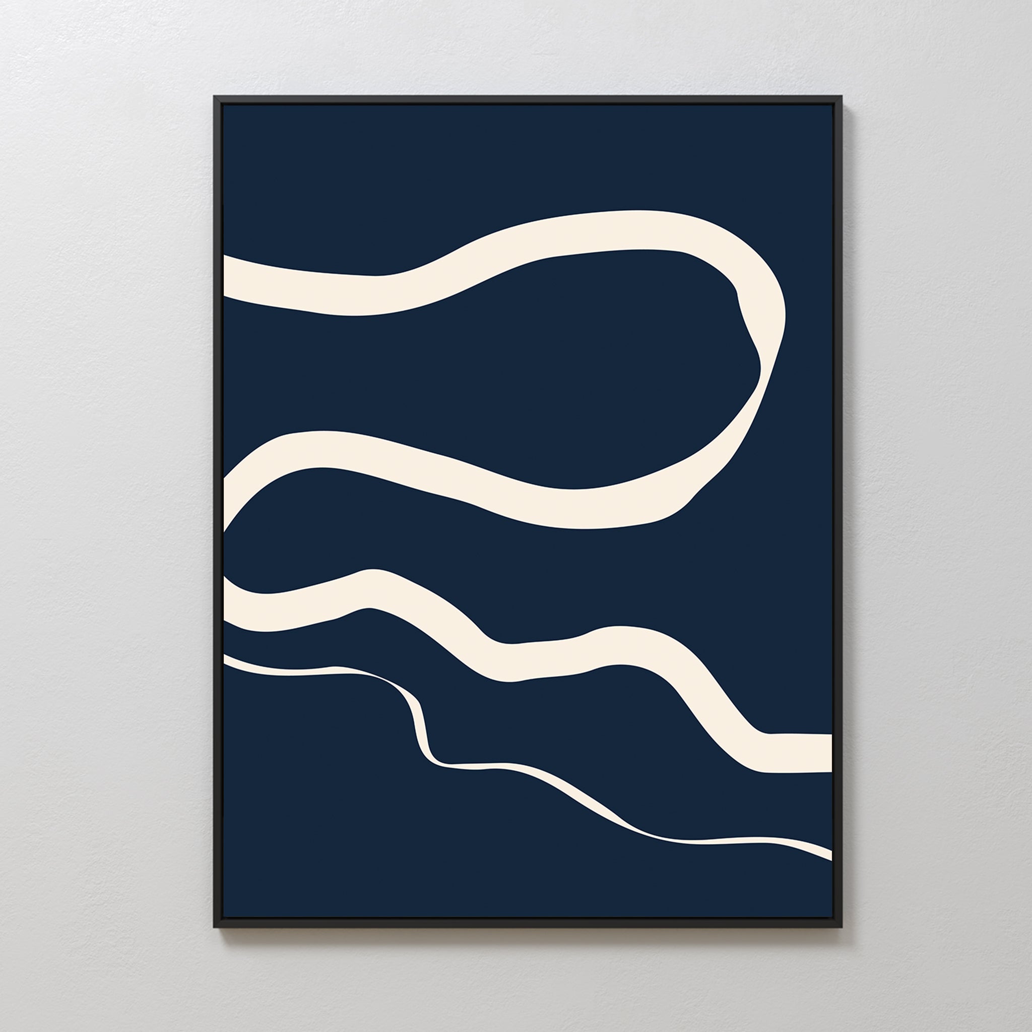 Blue Tranquility Abstract Canvas Art features three wavy cream lines on a dark navy backdrop, framed and displayed on a light gray wall. This minimalist piece brings organic, flowing shapes to your living room decor.