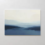 Blue Valley Mist Canvas Art features soft, blurry blue and white tones that evoke a misty landscape of distant hills or water beneath a pale sky—ideal for adding calming, minimalist decor to your space.