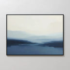 Blue Valley Mist Canvas Art showcases soft, blended blue and white tones that evoke a tranquil, misty landscape. Its calm design and sleek black frame make it ideal for minimalist decor.