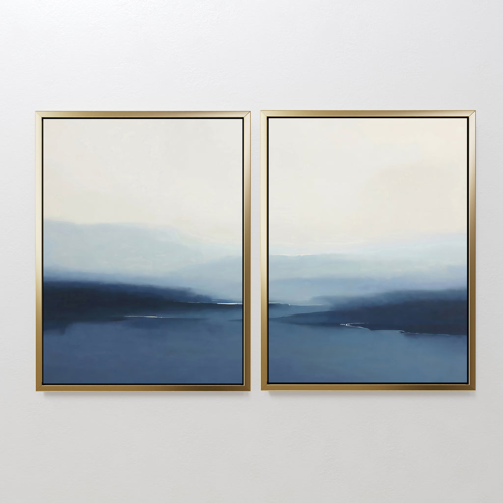 The Blue Valley Mist Set of 2 features wall art prints with gold frames and blue-white gradients, evoking misty landscapes or seascapes—ideal minimalist decor for a white wall.