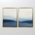 The Blue Valley Mist Set of 2 features wall art prints with gold frames and blue-white gradients, evoking misty landscapes or seascapes—ideal minimalist decor for a white wall.