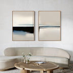 A modern living room with a curved beige sofa, round wooden coffee table with a vase of flowers, and the Blurred Reflections Set of 2 abstract minimalist wall art prints in neutral tones hanging on a white wall.