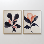The Blush & Shadow Set of 2 features framed abstract botanical prints with stylized leaves in dark navy and soft coral, displayed side by side on a white wall. The light background enhances the organic shapes and modern color gradients.