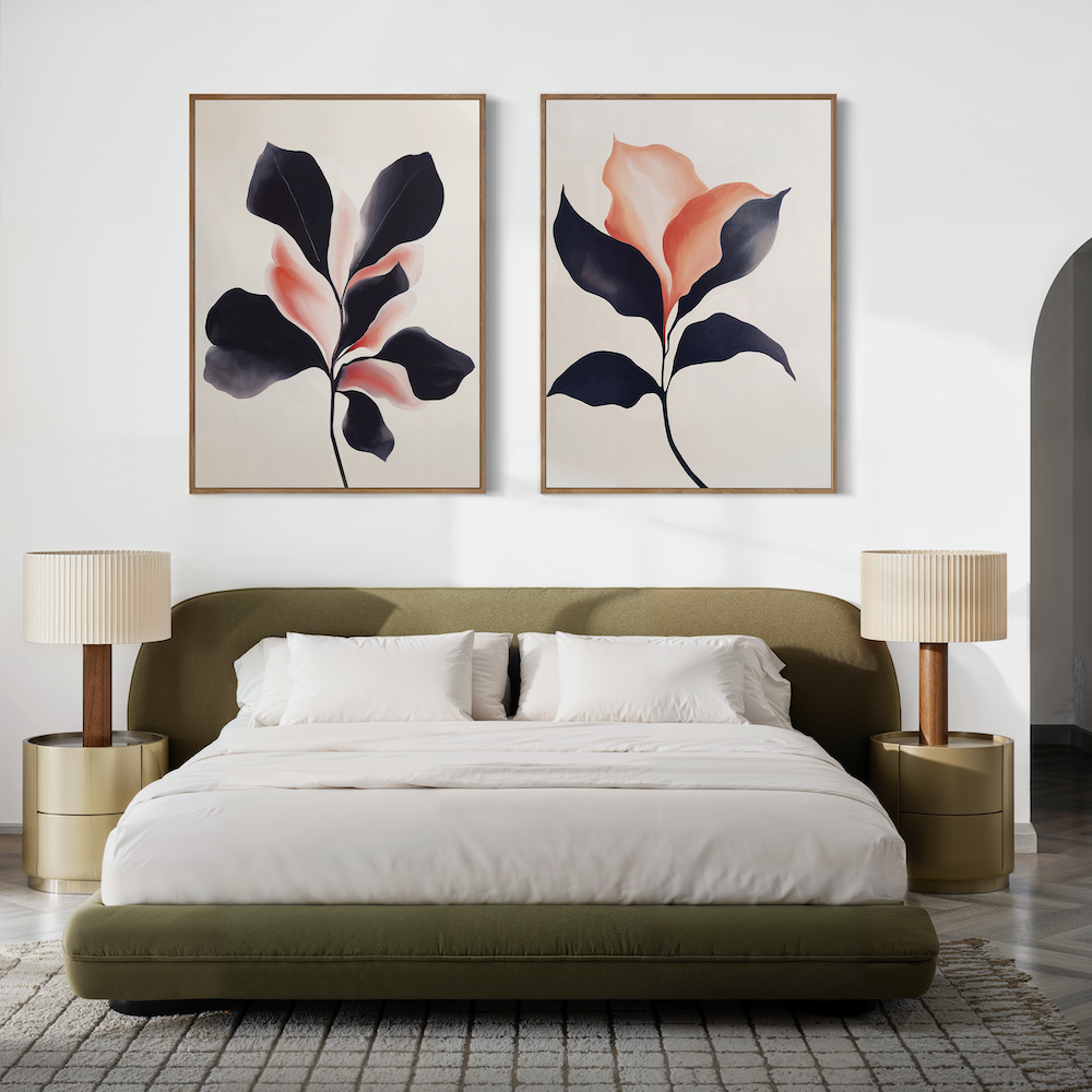 A modern bedroom features an olive-green bed with white bedding, beige nightstands with matching lamps, and the Blush & Shadow Set of 2 botanical art prints above the headboard on a crisp white wall for a fresh, serene vibe.