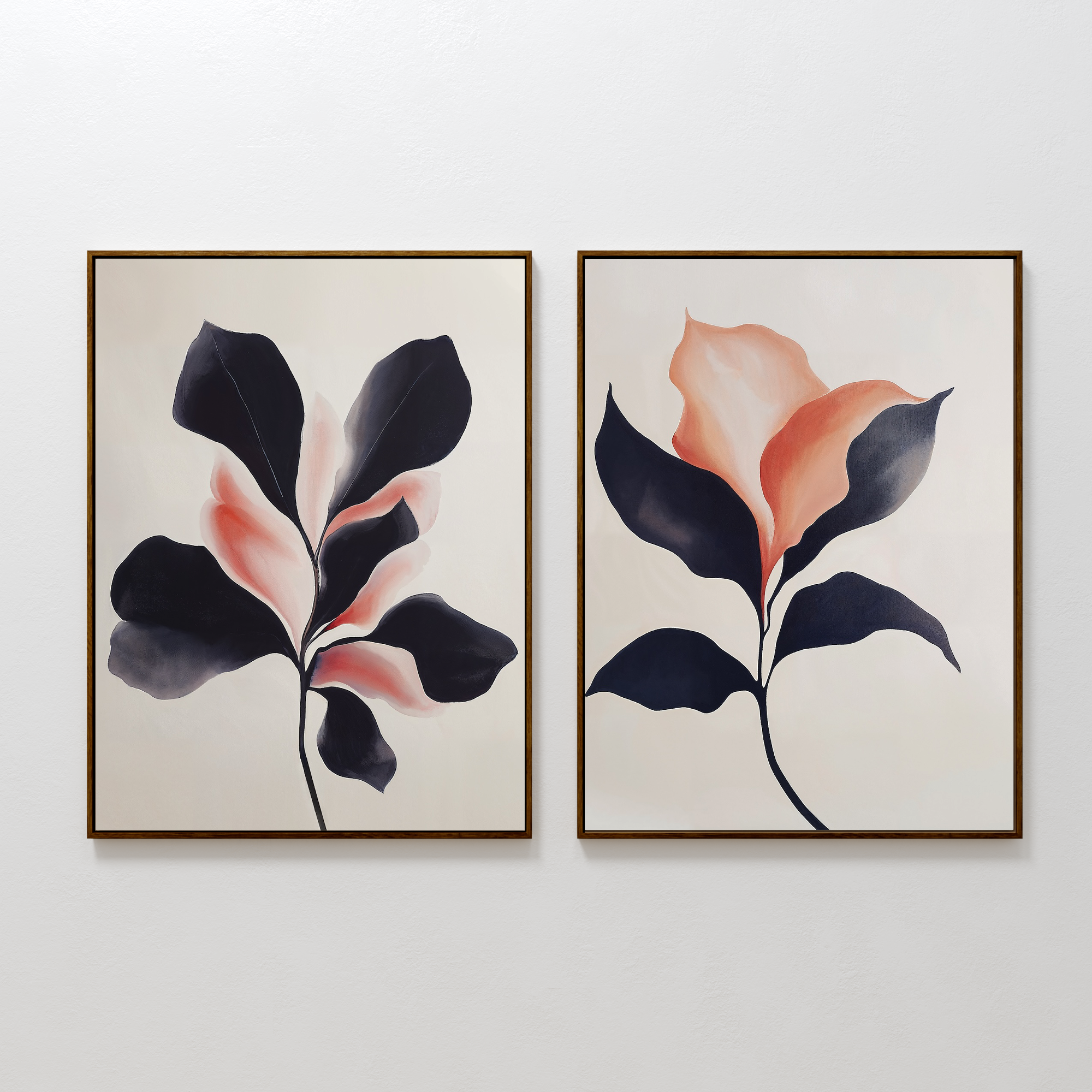 The Blush & Shadow Set of 2 features framed abstract leaf paintings in dark navy and soft peach tones, displayed side by side on a white wall.
