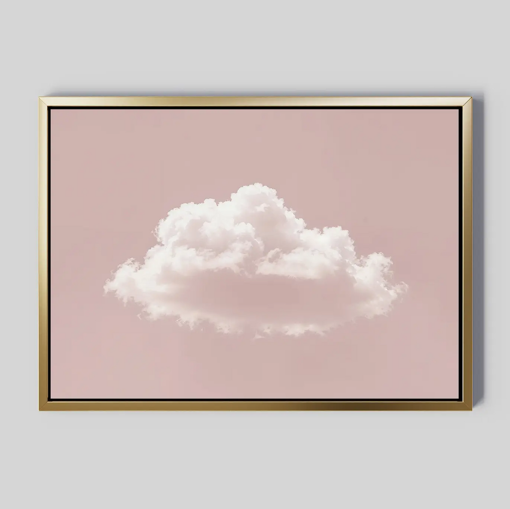 The Blushing Sky Canvas Art features a single fluffy white cloud centered on a soft pink background with a thin gold frame—ideal minimalist decor for any bedroom wall art collection.