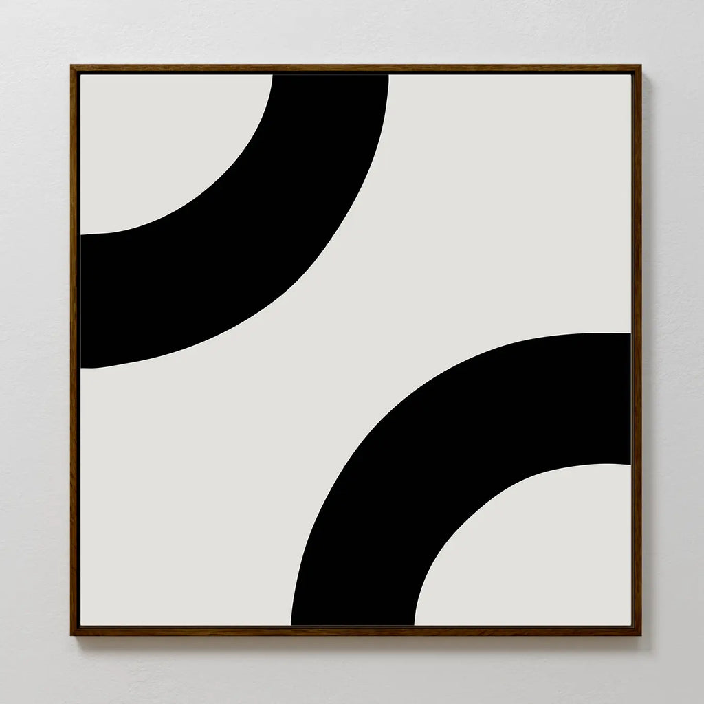 Bold Orbit Canvas Art is a minimalist square print featuring two thick black curves on light gray. Its bold, abstract design in a wooden frame makes it the perfect modern wall art for elevating contemporary interiors.
