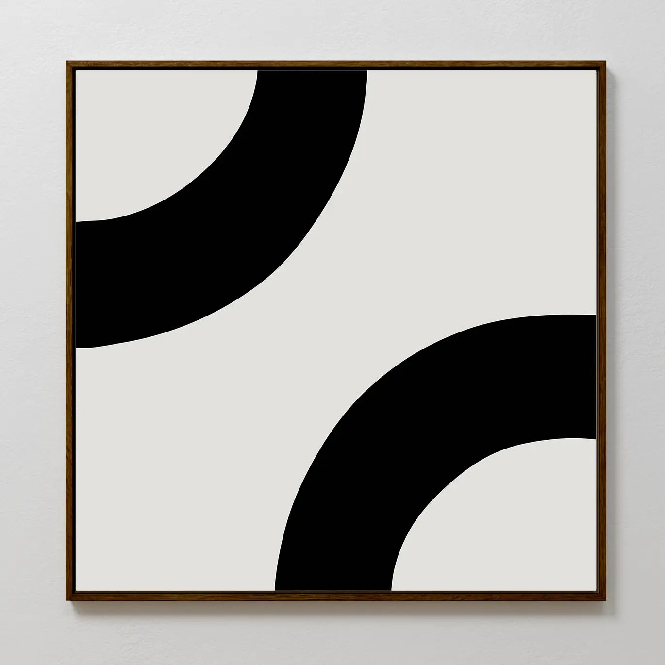 Bold Orbit Canvas Art is a minimalist square print featuring two thick black curves on light gray. Its bold, abstract design in a wooden frame makes it the perfect modern wall art for elevating contemporary interiors.