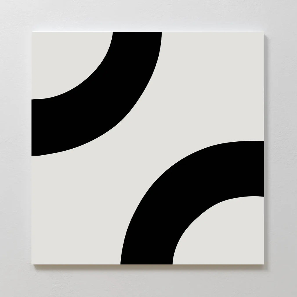 Bold Orbit Canvas Art showcases two thick black curved arcs on a white square canvas, each partially visible at opposite corners, creating a striking minimalist geometric design ideal for modern interiors.