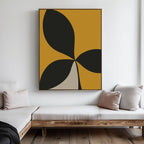 A minimalist living room features wooden furniture, light cushions, and the Botanic Contrast Abstract Canvas Art—a large black, gold, and beige focal piece—displayed on a white wall to complete the decor.