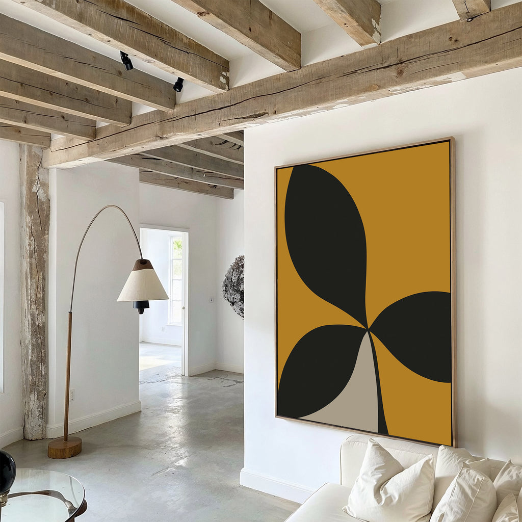 A modern living room with exposed wooden ceiling beams, white sofa, and white walls is elevated by the Botanic Contrast Abstract Canvas Art with black and gold shapes—perfect for stylish decor.
