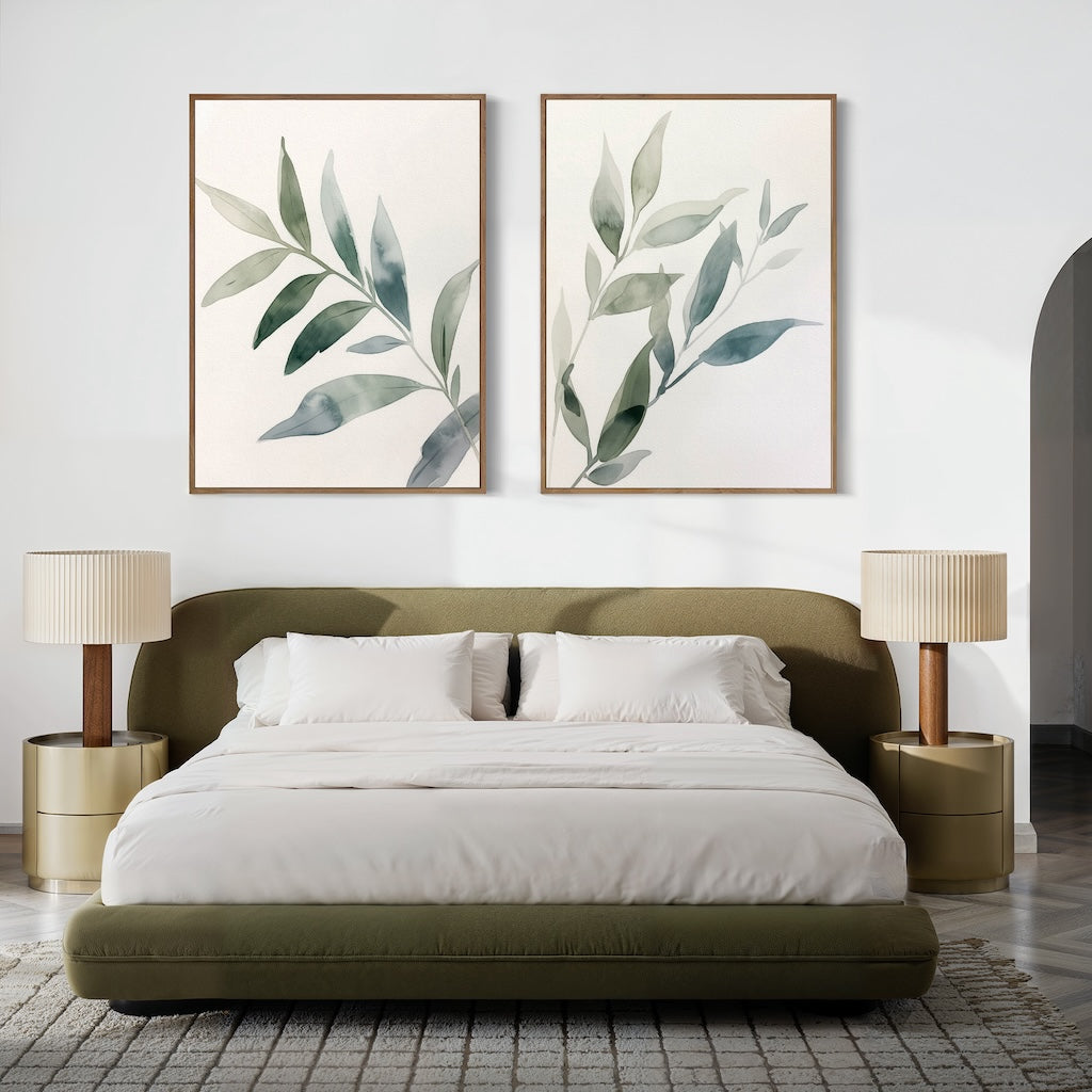 A modern bedroom with a low olive-green bed, white bedding, two beige nightstands with matching lamps, and the Botanical Breeze Set of 2 minimalist wall art above the bed. The space features neutral tones and a textured rug.