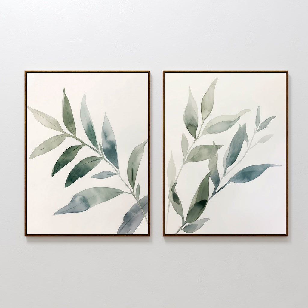 The Botanical Breeze Set of 2 features framed watercolor prints of green leafy branches on a white background, adding calming, minimalistic style and fresh green leaves decor to any room. Perfect as wall art for a tranquil atmosphere.