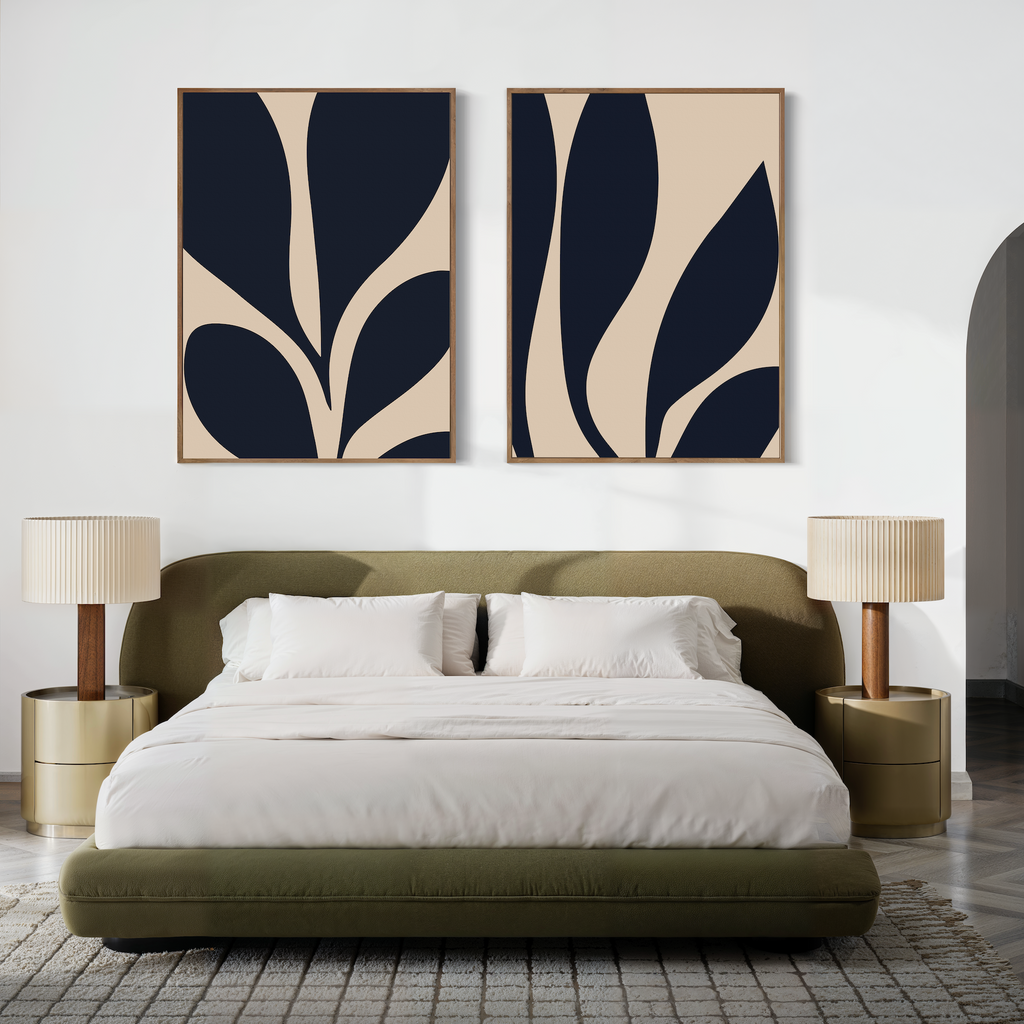 A modern bedroom with an olive green upholstered bed, white bedding, gold bedside tables with pleated lamps, and the Botanical Ink Set of 2—large minimalist wall art featuring abstract black and beige leaf prints.