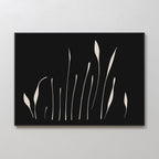 Botanical Silhouettes Abstract Canvas Art features minimalist wall decor with a black background and cream curved lines resembling abstract grass or floral shapes, beautifully framed and displayed on a light wall.