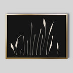 Botanical Silhouettes Abstract Canvas Art features cream floral silhouettes on black in a gold frame, ideal as minimalist wall art for light gray walls.