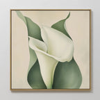 The Calla Duo Canvas Art features a framed white calla lily with soft green leaves on a light beige background. This minimalist wall art’s smooth, elegant curves bring modern decor to any room.