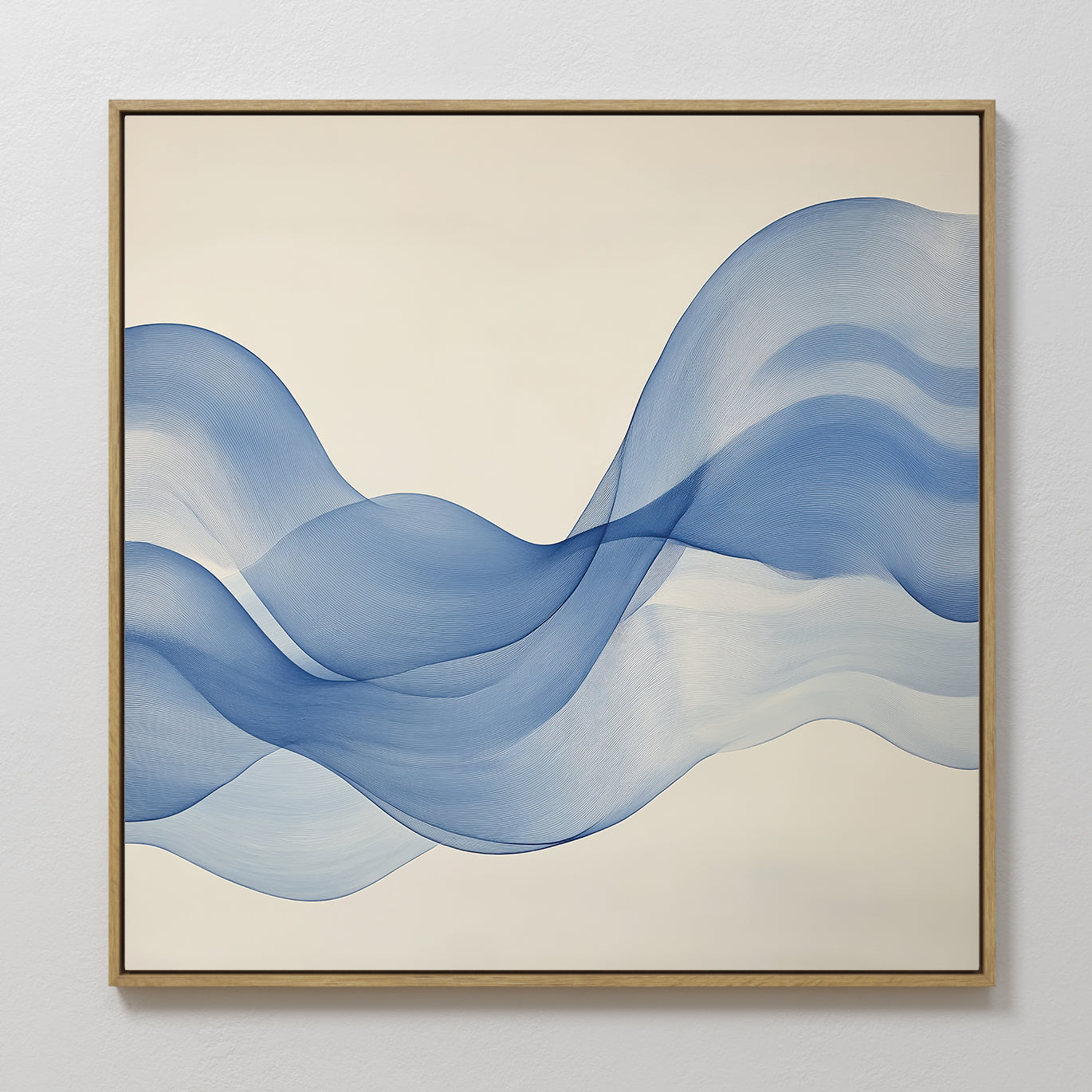 The Calm Swell Canvas Art features flowing blue wave shapes on a cream background with a thin gold frame. This large wall art adds movement and calm, making it ideal for modern living room decor.