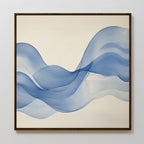 The Calm Swell Canvas Art features flowing blue waves on a cream background, framed in a slim dark brown frame—ideal for adding movement and fluidity to modern living room decor.