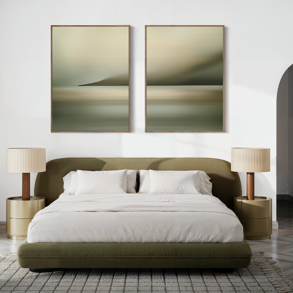 A modern bedroom features the Calm Waterscape Set of 2 paintings above a green bed with white bedding, gold nightstands, and beige lamps. Neutral tones and a textured rug complete the serene look.