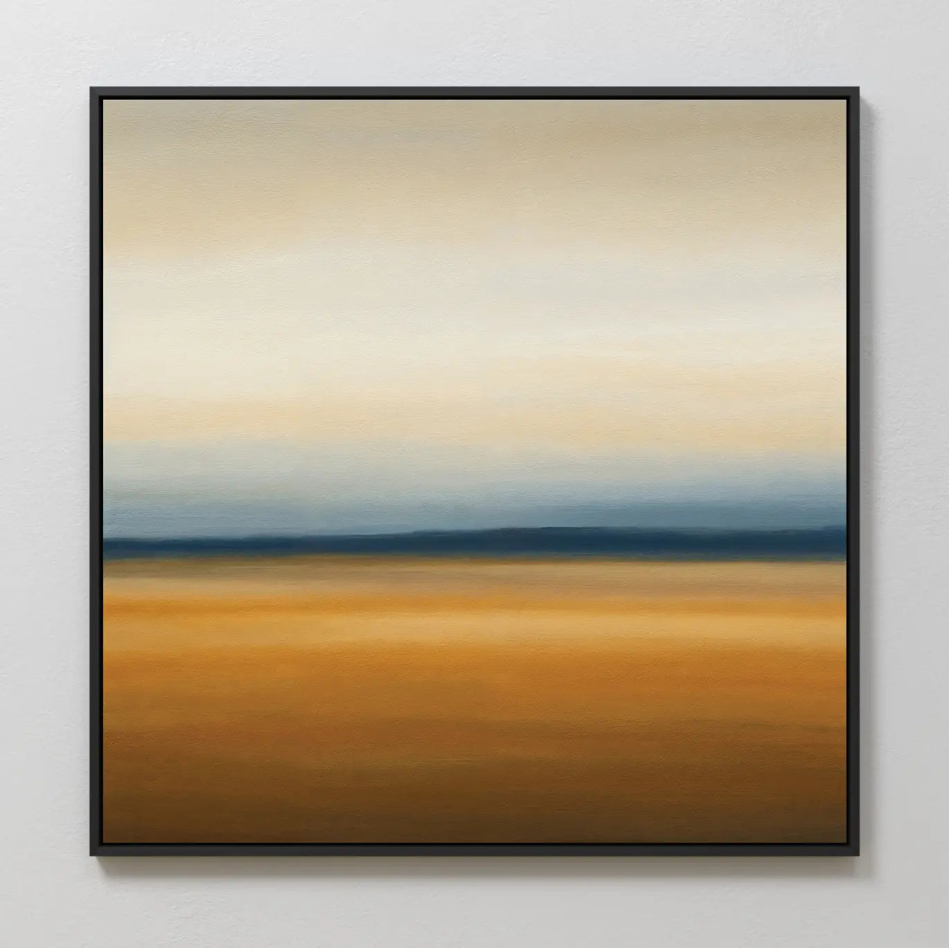 Caramel Plains Canvas Art showcases blended bands of warm golden brown with cool blue and soft gray, creating a tranquil abstract landscape. Perfect for modern bedroom decor, it comes framed in black and displayed on a white wall.
