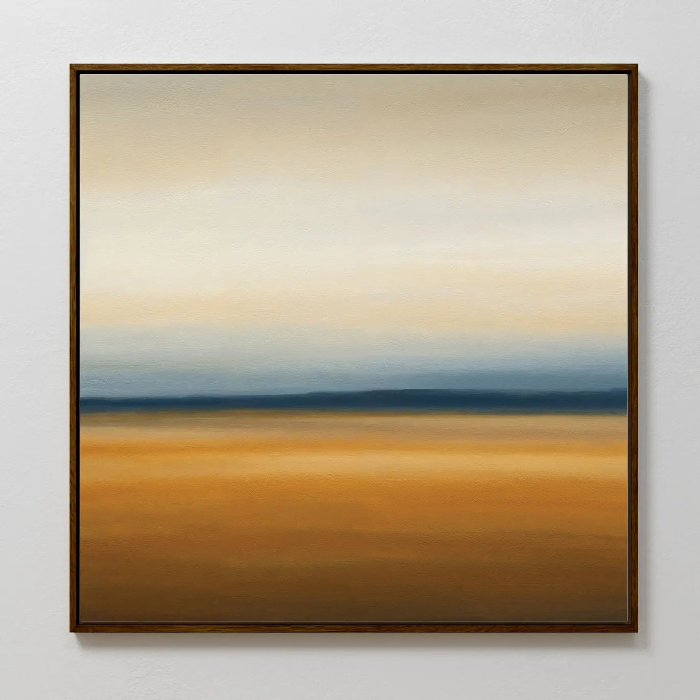 The Caramel Plains Canvas Art features horizontal bands of beige, blue, and golden brown for a serene landscape effect. Simply framed and ideal for modern bedroom decor, it looks stunning on a light-colored wall.