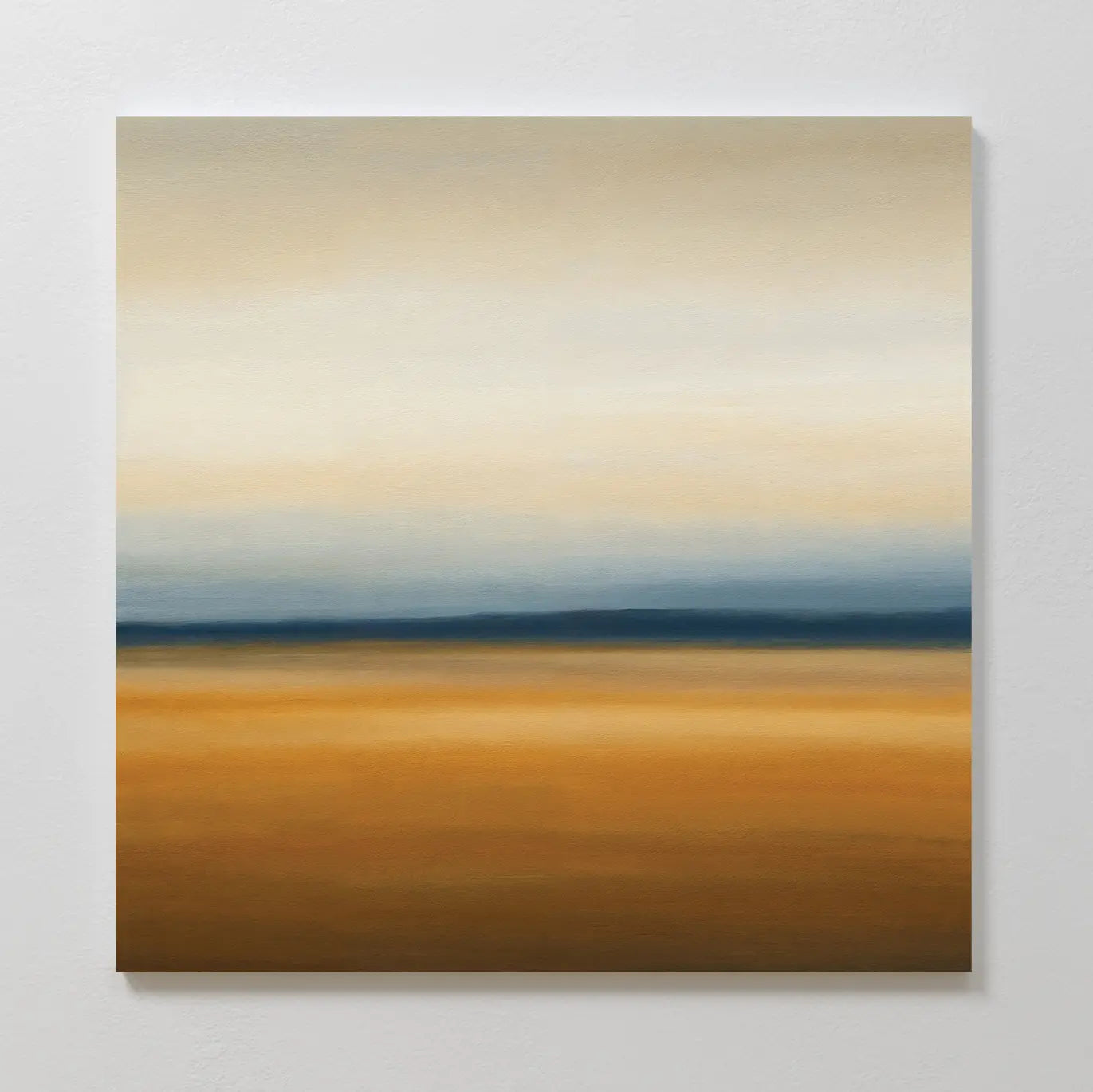 The Caramel Plains Canvas Art features soft horizontal bands of warm brown and gold at the base, blending into deep blue and beige above—a serene landscape perfect for modern bedroom decor.
