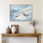 The Chalet View Canvas Art, a framed painting of a winter village, hangs on a beige wall above a wooden table styled with neutral vases, a basket, dried flowers, and a wooden grid—ideal minimalist wall art decor.