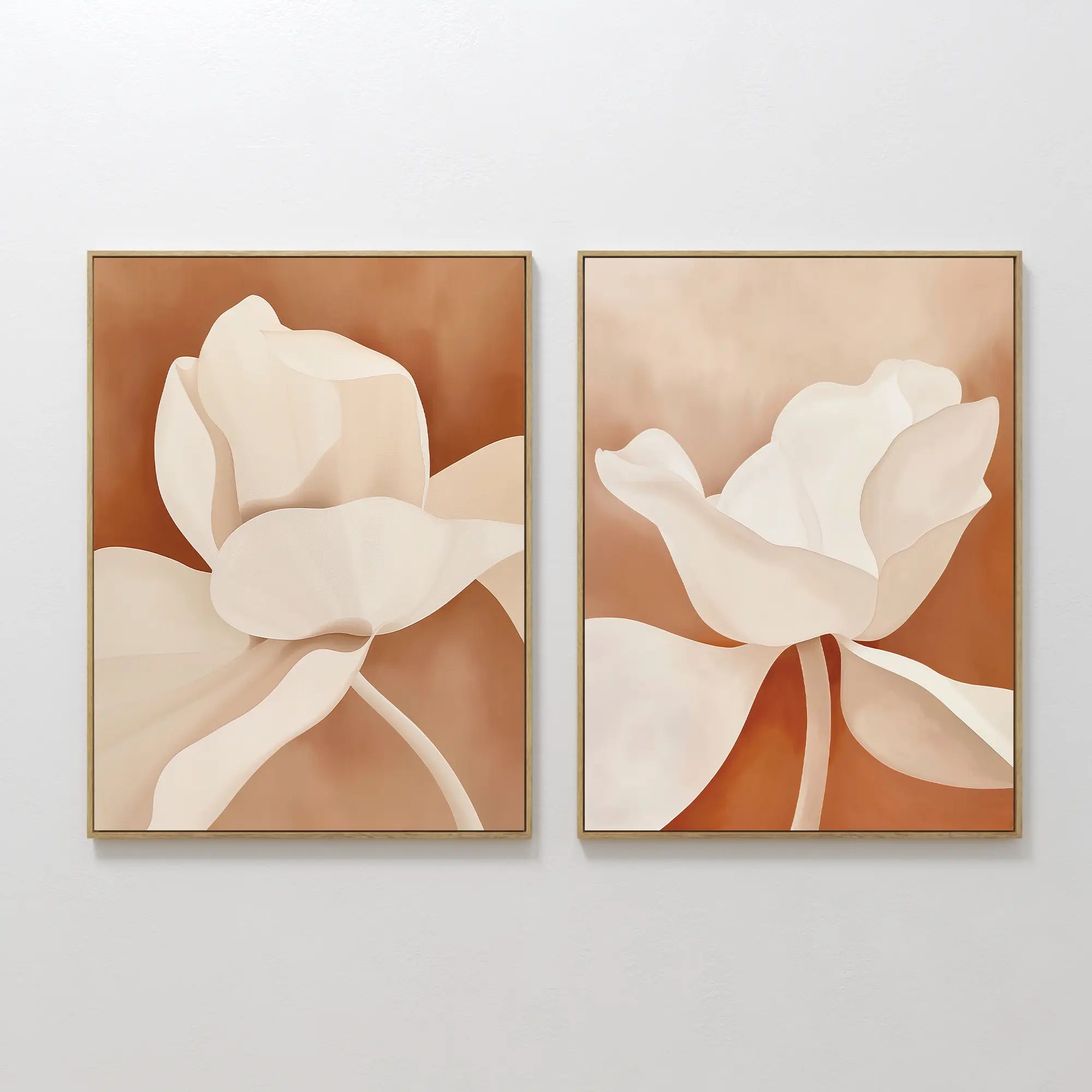 The Clay Blossom Set of 2 features framed abstract floral prints with beige and white flowers on a terracotta background. Displayed side by side, these artworks showcase soft, flowing shapes and minimal detail for a modern touch.