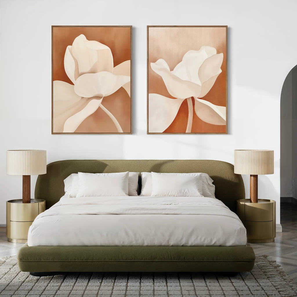 A modern bedroom featuring an olive green upholstered bed with white bedding, beige nightstands and matching lamps, and the Clay Blossom Set of 2 floral wall art prints in cream tones above the bed.