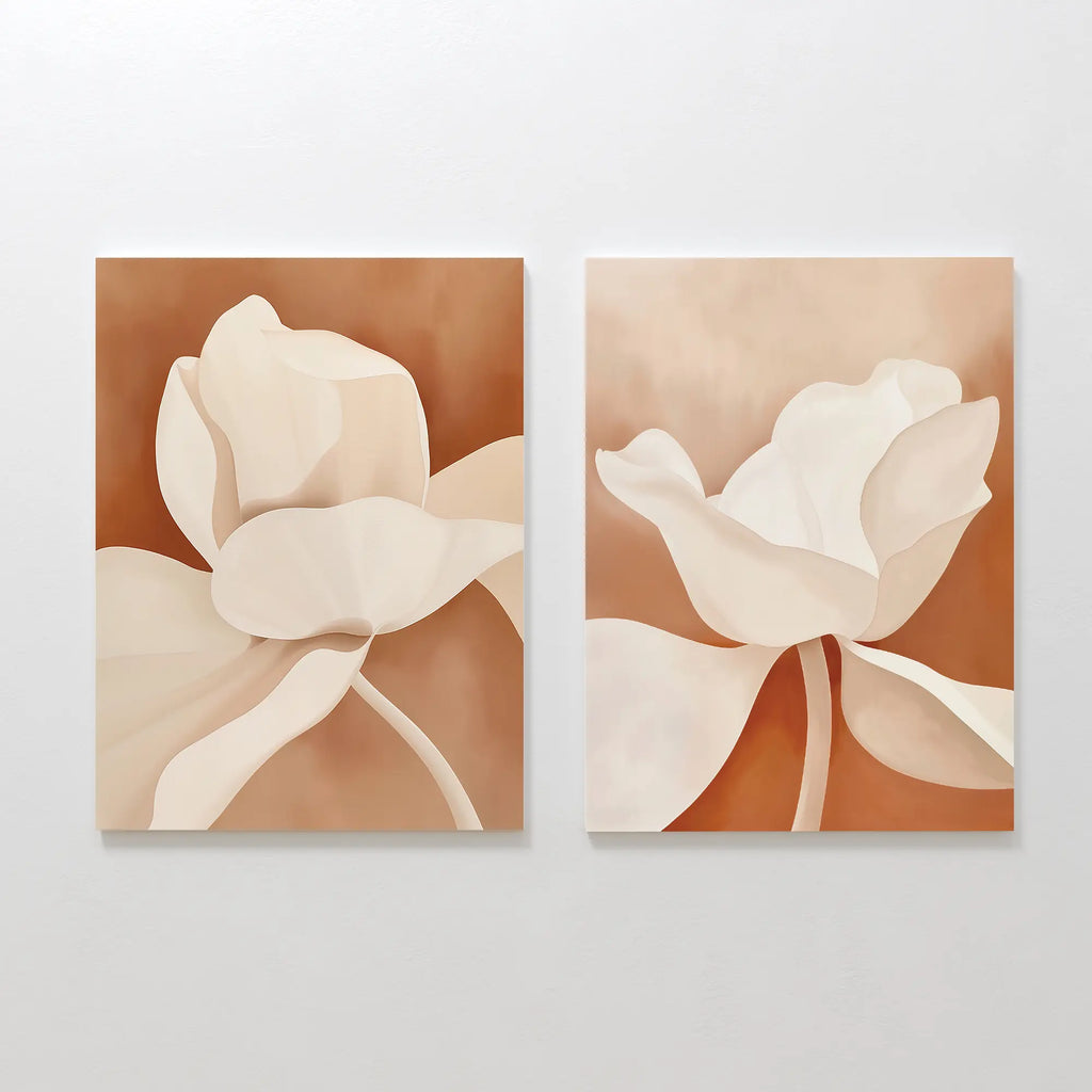 The Clay Blossom Set of 2 features abstract floral wall art prints with large cream flowers and soft petals on a warm brown background, creating elegant terracotta-inspired decor perfect for display on a white wall.