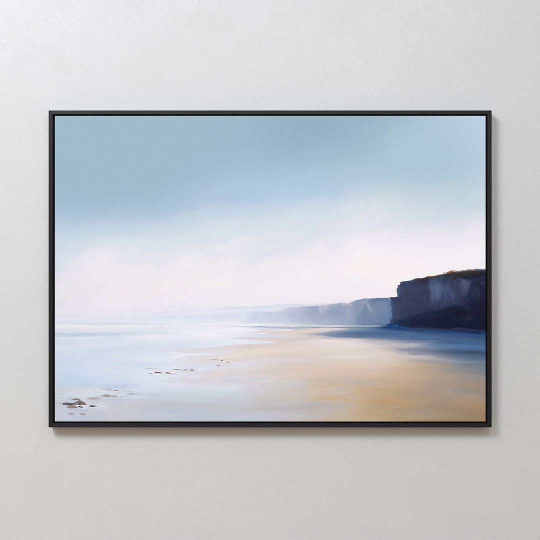 The Cliffside Light Canvas Art – Horizontal features a tranquil coastal scene with sandy beach, soft waves, and distant cliffs beneath a misty blue sky—ideal for adding a serene touch to any bedroom.