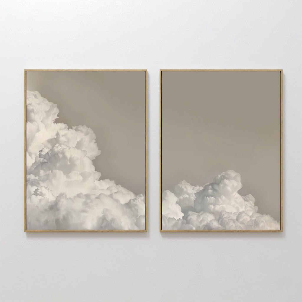 The Clouded Dreams Set of 2 features framed wall art prints depicting soft clouds against a muted beige sky, creating a minimalist canvas set perfect for elevating your living room decor.