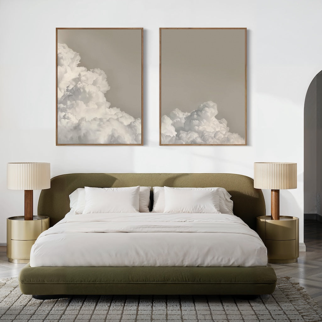 A modern bedroom with an olive green bed, white bedding, beige nightstands and lamps, a textured rug, and the Clouded Dreams Set of 2 wall art prints above the bed—ideal for lovers of minimalist canvas set style.