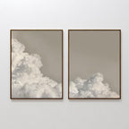 The Clouded Dreams Set of 2 includes minimalist canvas prints featuring fluffy white clouds on a soft beige-gray sky. The left print has more clouds, while the right is more open and airy—ideal for stylish living room decor.
