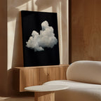 Cloud In Darkness Abstract Canvas Art—a white fluffy cloud on a black background—adds a modern, minimalist touch above the white sofa and round coffee table in rooms with beige walls. Perfect wall art for contemporary interiors.